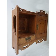 a wooden cabinet with two drawers on the front and one door open to reveal another drawer