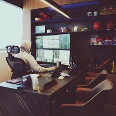 a person sitting at a desk in front of a computer monitor with a basketball on it