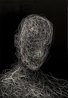 a black and white photo of a person's head made out of tangled wire