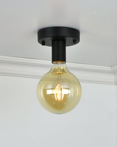 a light bulb is hanging from the ceiling in a room with white walls and ceilings