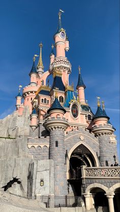 the castle is pink and blue with gold trim