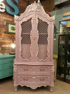 an old pink china cabinet in a store