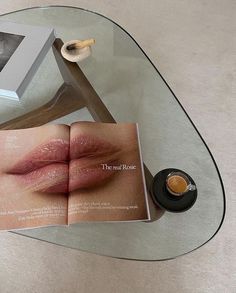 an open magazine sitting on top of a glass table