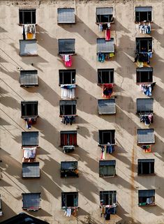 an overhead view of several windows with clothes hanging out to dry in the sun on a sunny day