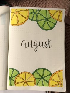 an open notebook with the word august written in black ink and oranges on it