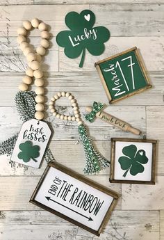 st patrick's day crafts and decorations on a wooden table with shamrocks, cross, name tags, and beads