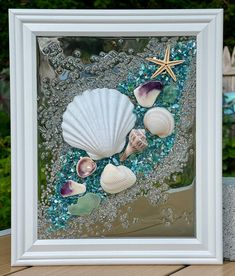 an image of seashells and starfish in the sand under water with bubbles