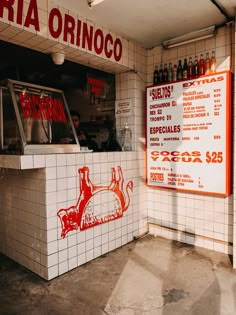 the interior of a mexican restaurant with menus on the wall and signs above it