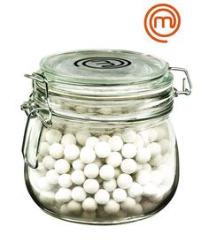 a glass jar filled with lots of white balls