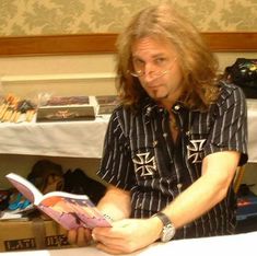 a man sitting at a table reading a book