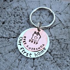 a keychain that says, our first home on the front and back of it