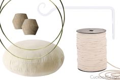 two spools of twine next to a roll of thread and a round object