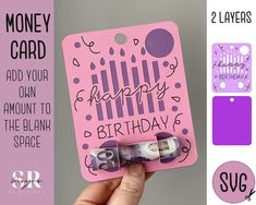 someone holding up a pink birthday card with the words happy birthday written on it and money clips