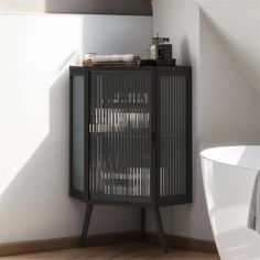 a bathroom with a black cabinet next to a white bath tub