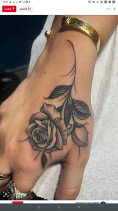 a woman's hand with a rose tattoo on it