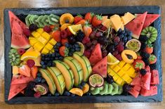 a platter filled with lots of different types of fruit