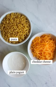 three bowls filled with different types of food on top of a white marble countertop