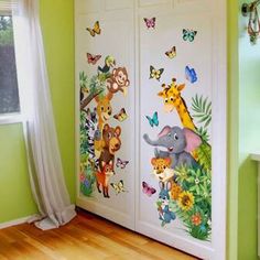 the children's room has two doors decorated with animals and butterflies on them, along with a window