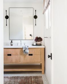 a bathroom with two sinks and a large mirror