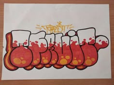 a piece of paper that has been drawn with red and yellow ink on it, which says graffiti