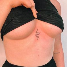 a woman's stomach with a snake tattoo on her left side and right breast