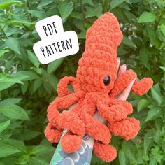 a hand holding an orange crocheted octopus with the words pdf pattern above it