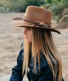 100% Wool Felt Distressed Handcrafted Ribbon Band Authentic Feather Artisian Drifter Brim Size: 3.25" Available in Sizes in S/M and L/XL Crafted from 100% wool felt, the Peter Grimm Unstoppable Cowboy Hat embodies timeless ruggedness and enduring style. Its tan hue exudes warmth, complementing any attire with effortless elegance. The distressed handcrafted ribbon band, adorned with an authentic feather, adds a touch of authenticity and character. With a brim size of 3.25 inches, this hat strikes the perfect balance between functionality and fashion, offering ample shade and protection from the elements. Available in sizes S/M and L/XL, it ensures a comfortable and tailored fit for every wearer, making it an essential accessory for any adventurer or cowboy at heart. Western Fur Felt Boater Hat With Curved Brim, Country Style Brown Hat With Feathers, Brown Fur Felt Country Fedora, Western-themed Fur Felt Fedora With Flat Brim, Western Hats For Women, Western-style Brimmed Fur Felt Fedora, Felt Cowboy Hat, Cowboy Hat Bands, Felt Cowboy Hats