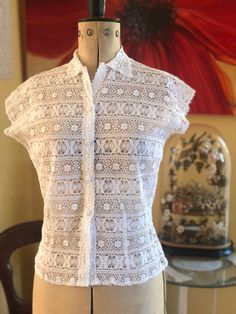 "A pretty white cotton lace blouse with shirt collar and front covered buttons. A very elegant blouse.  I don't know the name of this lace but it appears to be a very fine crochet. In excellent condition. Handmade  Size Medium  Bust 36\" Waist 29\" Length 20\"" Summer Collared Lace Blouse, Collared Lace Blouse For Summer, Summer Lace Blouse With Collar, Fitted Collared Lace Tops, Classic White Tops With Lace Work, Classic White Lace Tops, Elegant Cotton Lace Daywear Top, Collared Lace Blouse With Lace Top, Classic Lace Blouse