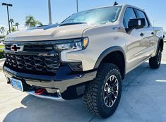 a silver truck parked in a parking lot