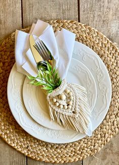 a place setting with white plates and silverware