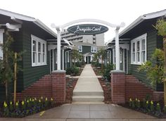 the entrance to an apartment complex with green siding and white trim