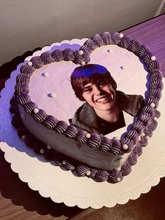 a heart shaped cake with a photo on it