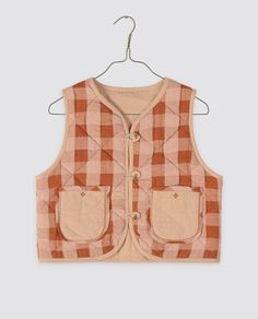 A lovely layering piece which is reversible and is perfect over our blouses, t-shirts and dresses. Made with our seersucker gingham on one side, contrasting plain fabric on the other, and finished with piping all the way around. This waistcoat has patch pockets on both sides with contrasting edging and embroidery. It really is a great, versatile piece. This waistcoat is quilted and fastens at the front with a buttons and fabric loops. 100% organic cotton outer fabric and 100% cotton wadding inne Plain Fabric, Organic Cotton Clothing, Romper Outfit, Skirt And Blouse, Organic Clothing, Socks And Tights, And Dresses, Layering Pieces, Winter Collection