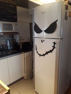 a refrigerator with an evil face painted on it