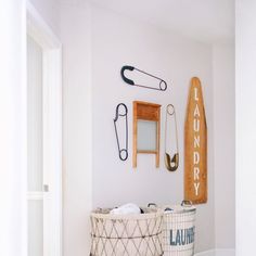 two laundry baskets sitting next to each other on the floor in front of a wall