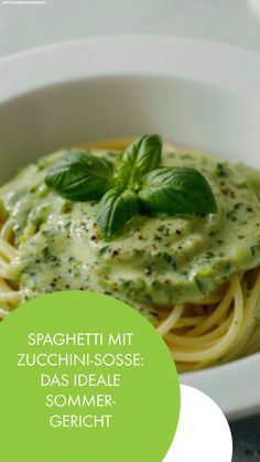 spaghetti with pesto sauce in a white bowl