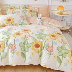 a bed with yellow and pink flowers on it