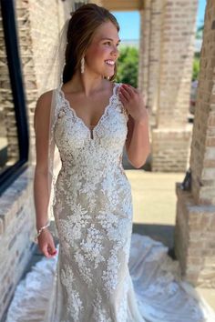 a woman in a wedding dress standing outside