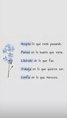 a blue flower sitting on top of a white wall next to a poem written in spanish