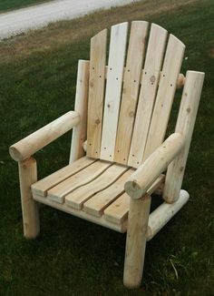 a wooden chair sitting in the grass