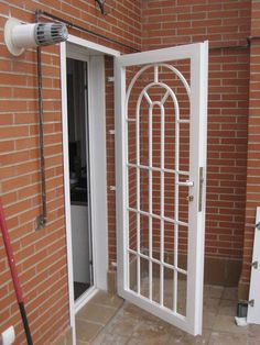 an open white door to a brick building