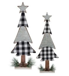 two wooden christmas trees with black and white plaid decorations