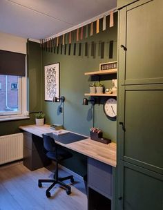 an office with green walls and wooden floors