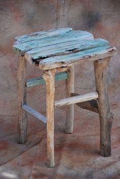 an old wooden stool made out of wood with no legs and one foot on the seat