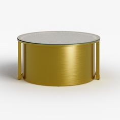 a gold coffee table with a glass top