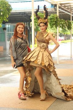 two women dressed in costumes standing next to each other