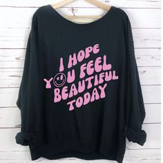 You’re Wearing The Friendliest Top Around Town “I Hope You Feel Beautiful Today” Graphic Sweatshirt Is Your Own Greeting Card To Everyone 50/50 Slouch Neck Long Sleeve High Quality Trendy Colors: Black White Gray Sizes: S M L Xl 2x 3x 4x 5x * Each One Is Hand Made * Each One Is Made With Love * Bundle To Save More Oversized Gray Slogan Tops, Oversized Gray Tops With Slogan, Trendy Black Tops With Lettering, Trendy Black Top With Lettering, Oversized Black Slogan Top, Black Casual Tops With Lettering, Casual Black Tops With Lettering, Gray Text Print Tops For Loungewear, Oversized Black Top With Lettering