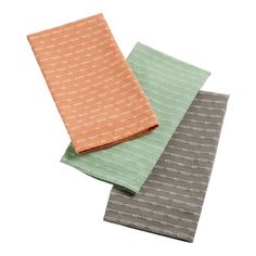 three different colored napkins sitting on top of each other