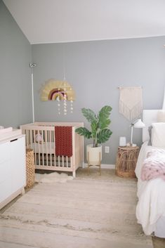 a baby's room with a crib, dresser and bed