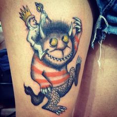 a tattoo with an image of a troll on it's thigh and a crown